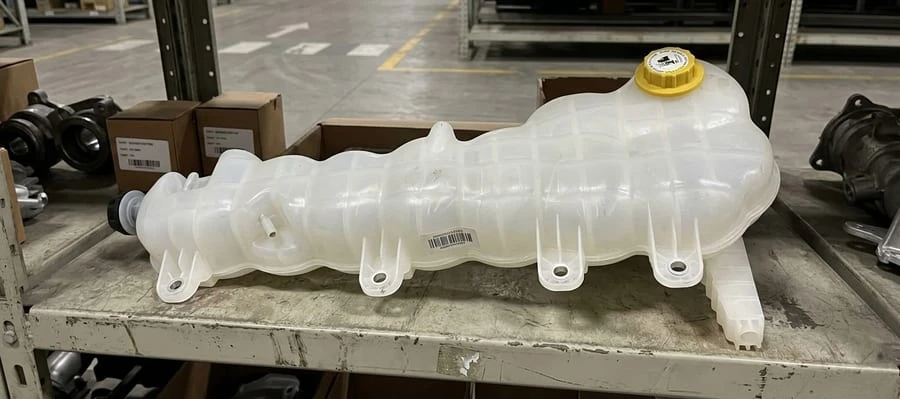 Semi truck coolant degas bottle and reservoir tank on warehouse shelf &mdash; OEM-spec replacement for Freightliner Kenworth Volvo Class 8 trucks